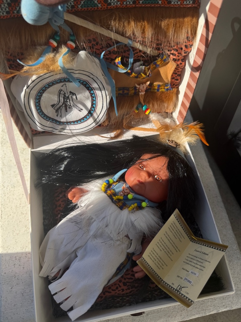 Native-inspired Baby Doll with Beaded Necklace and Feather Accents